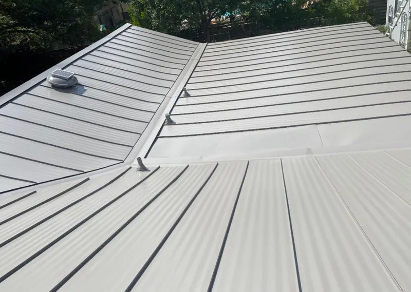 Solar attic fan installed on a metal roof for Roof Ventilation in Coral Gables